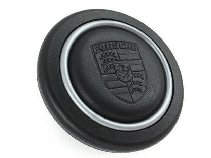 Porsche steering wheel button with shield finished in leather with silver ring for steering wheels, MOMO, SPARCO and OMP.
