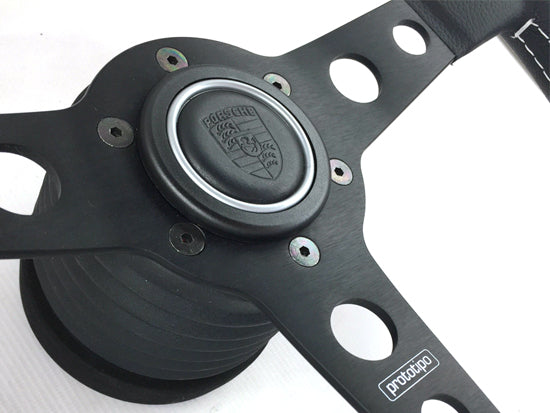 Porsche steering wheel button with shield finished in leather with silver ring for steering wheels, MOMO, SPARCO and OMP.