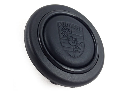 Porsche steering wheel button with leather-finished shield for MOMO, SPARCO and OMP steering wheels.